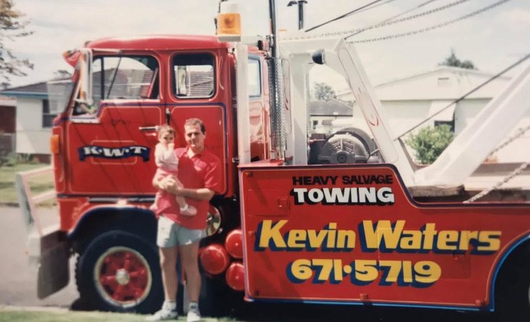 Kevin Waters with his young son beside the original red salvage wrecker