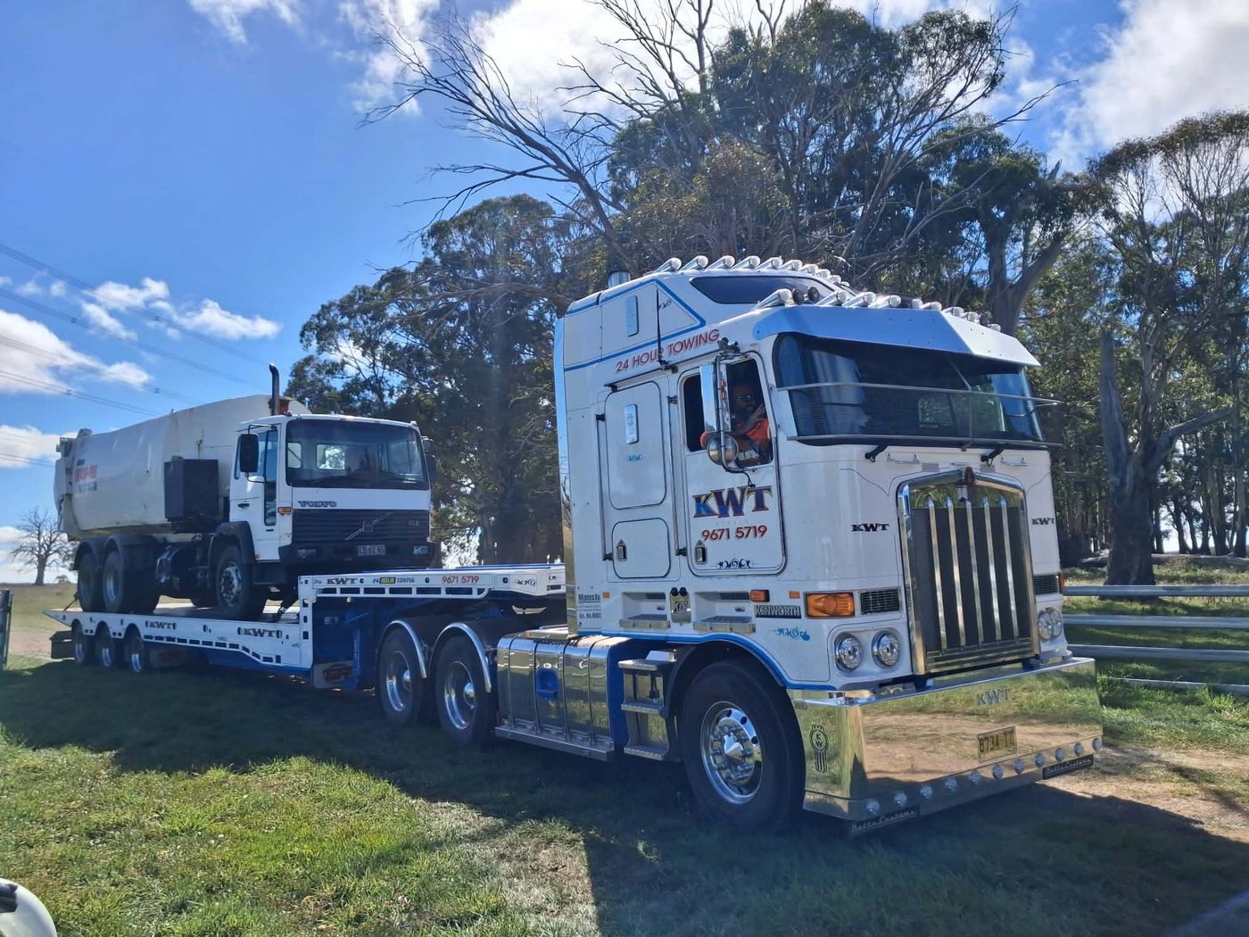KWT cabover Kenworth with a truck loaded and secured on the deck behind