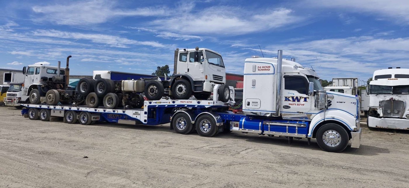 KWT low loader recovering heavy machinery, night shift call-out