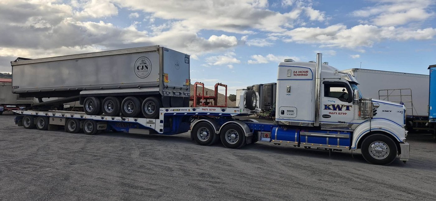 KWT prime movers with low loader trailers, Greater Sydney