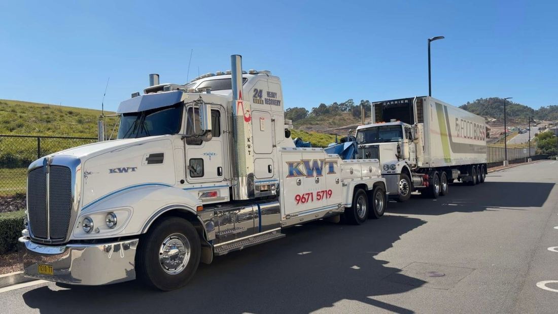 KWT trucks loaded for a daytime vehicle transport job