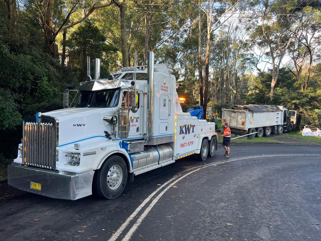 KWT trucks relocating site buildings on a regional road