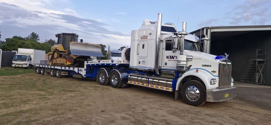 KWT low loader carrying an excavator
