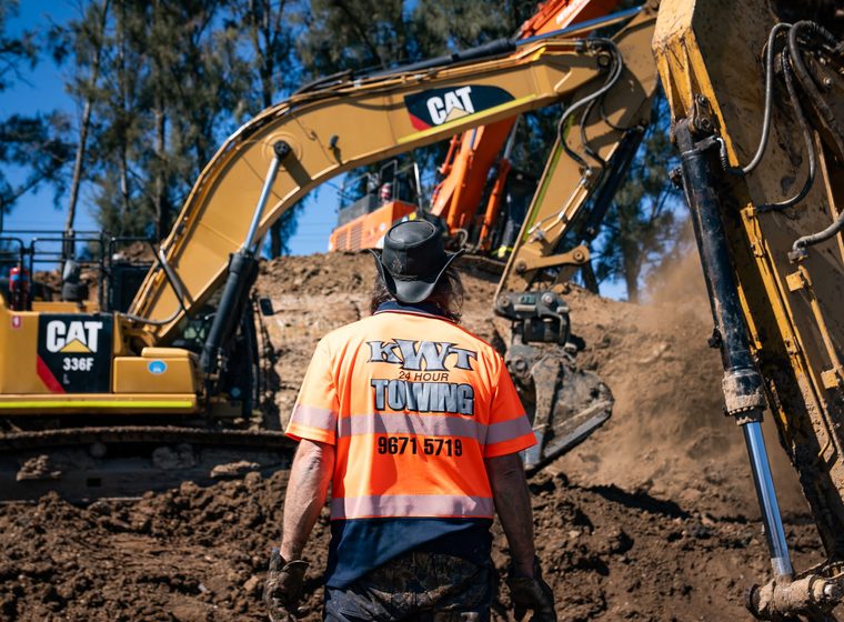 KWT crew working alongside a CAT excavator on site