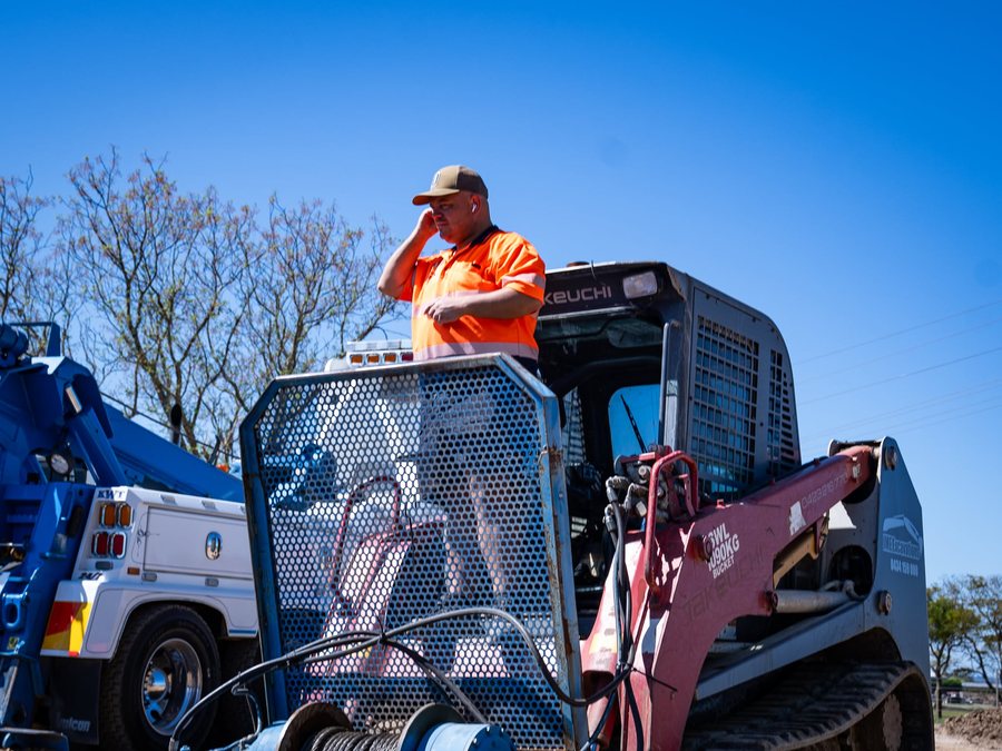 KWT operator surveying a bogged excavator recovery site
