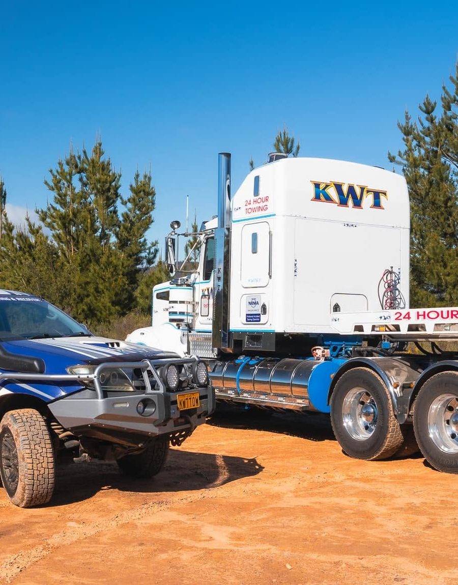 KWT flatbed carrying a car through Sydney