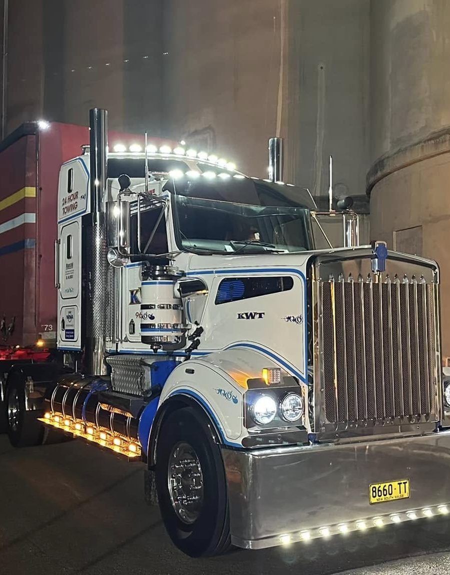 KWT heavy wrecker towing a prime mover and trailer