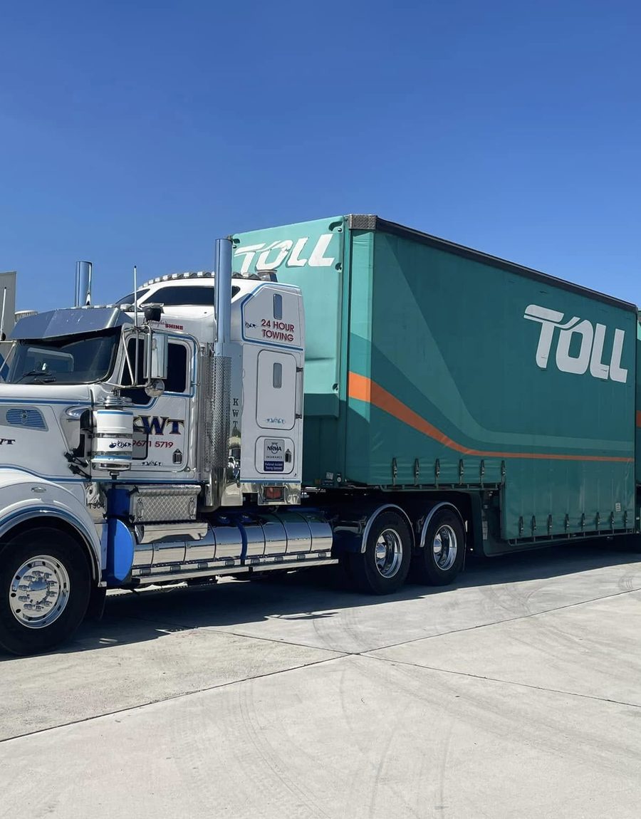 KWT truck transporting a container or portable building