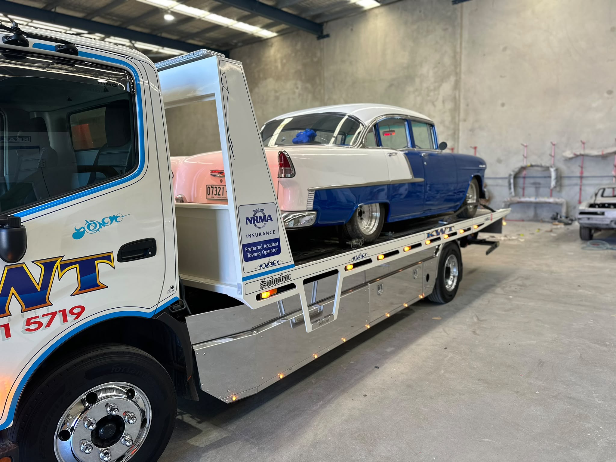 KWT tilt tray truck on the road, professional vehicle transport