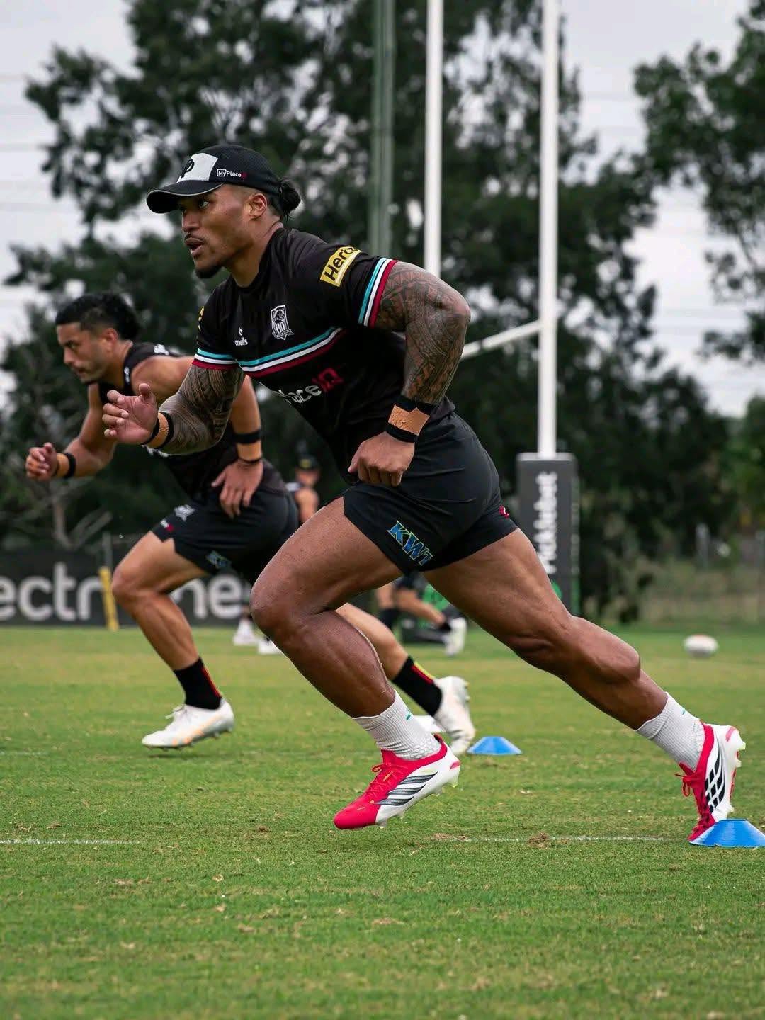 Penrith Panthers player sprinting at training, KWT branding on the playing shorts